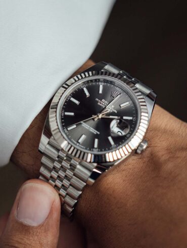 Close-up of a man's platinum luxury wrist watch.