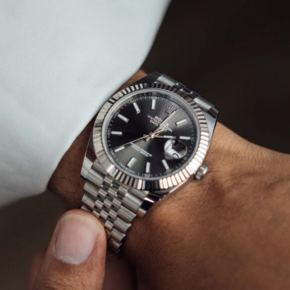 Close-up of a man's platinum luxury wrist watch.