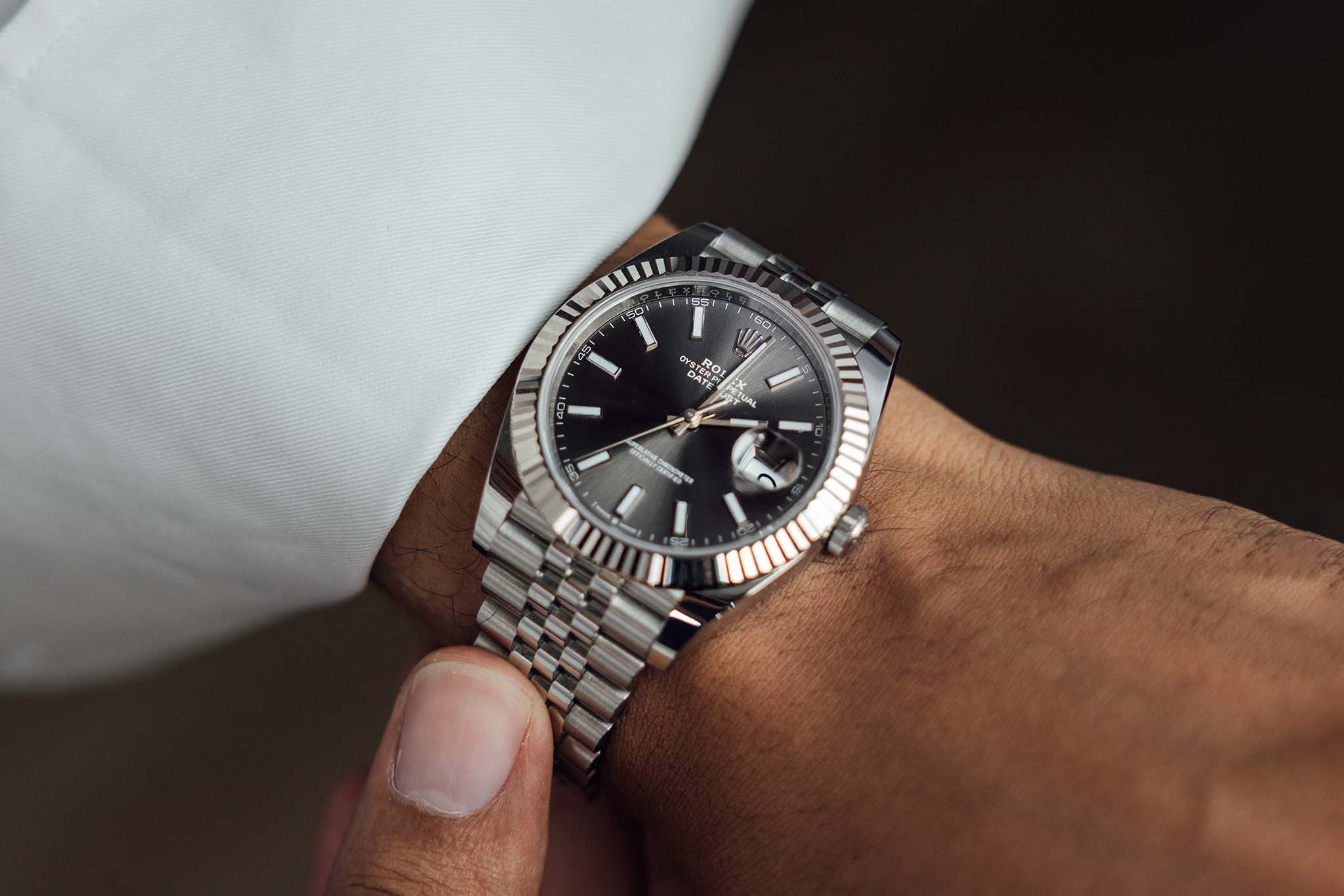 Close-up of a man's platinum luxury wrist watch.
