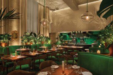 a restaurant with green tables and chairs