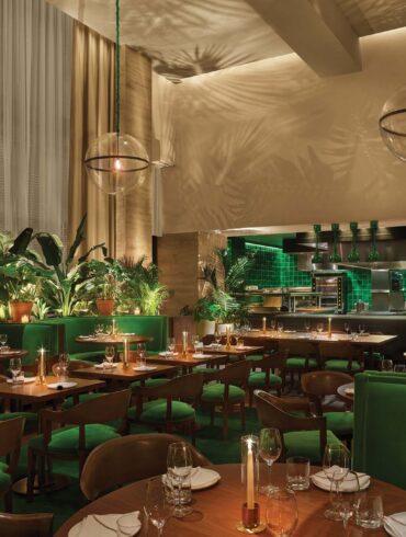 a restaurant with green tables and chairs