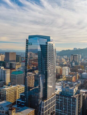 a tall glass building in a city