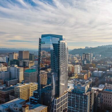 a tall glass building in a city