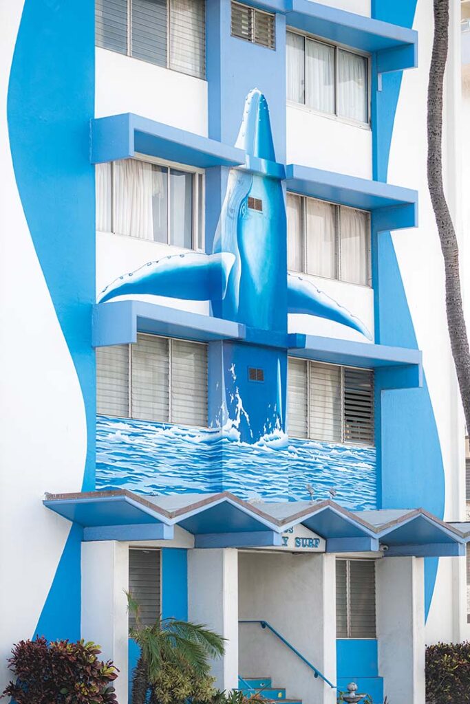 a blue and white building with a shark painted on the side
