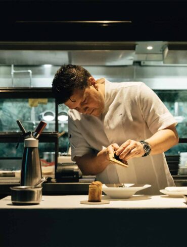 a person in a white shirt preparing food