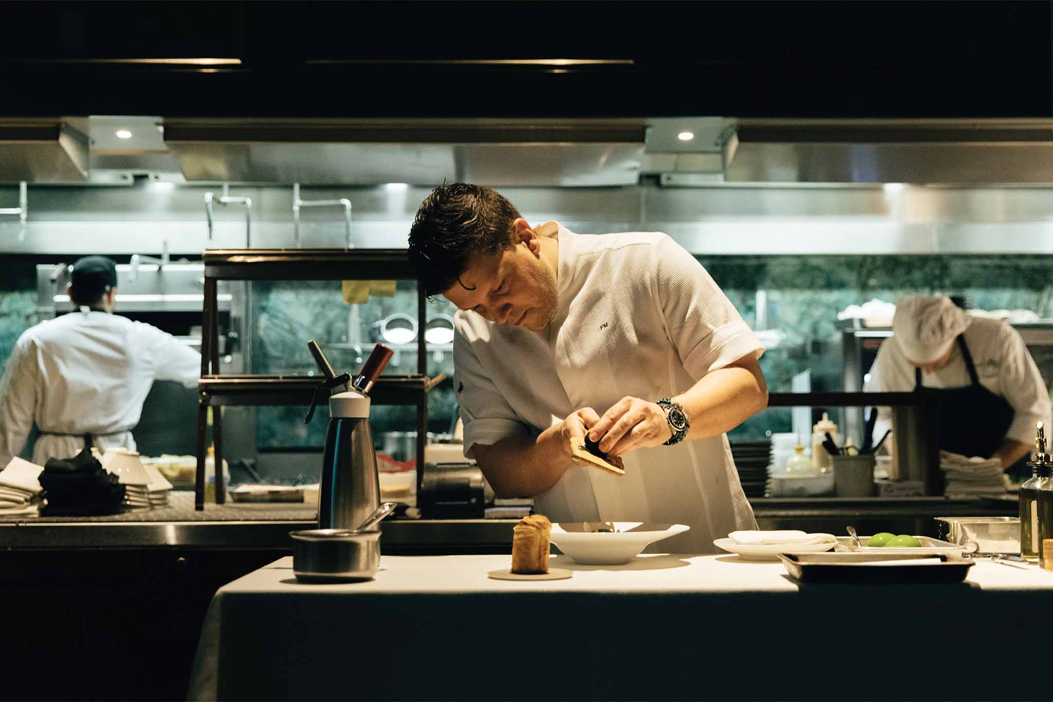 a person in a white shirt preparing food