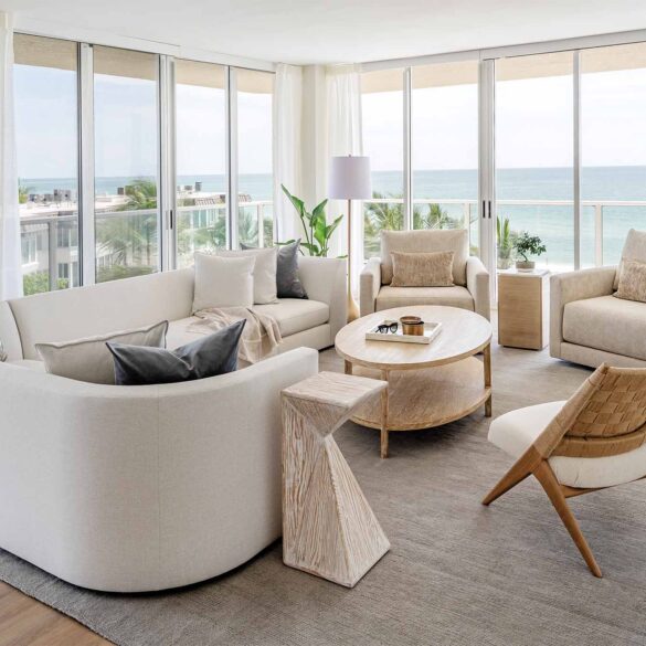 a living room with a large glass wall and a couch and a table