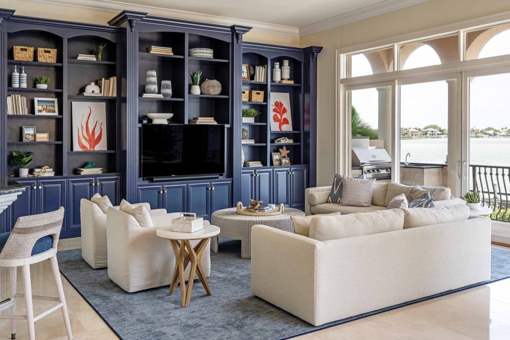a living room with a large bookcase and couches
