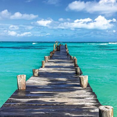 a wooden dock leading into the ocean