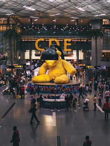 a large yellow stuffed bear in a large building
