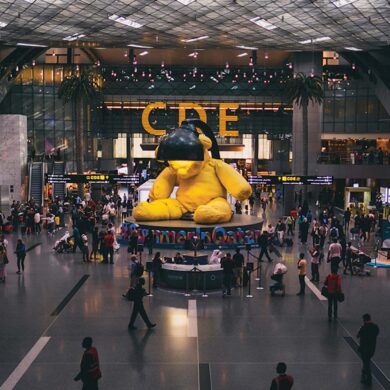 a large yellow stuffed bear in a large building