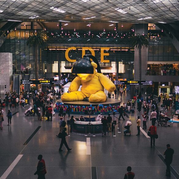 a large yellow stuffed bear in a large building