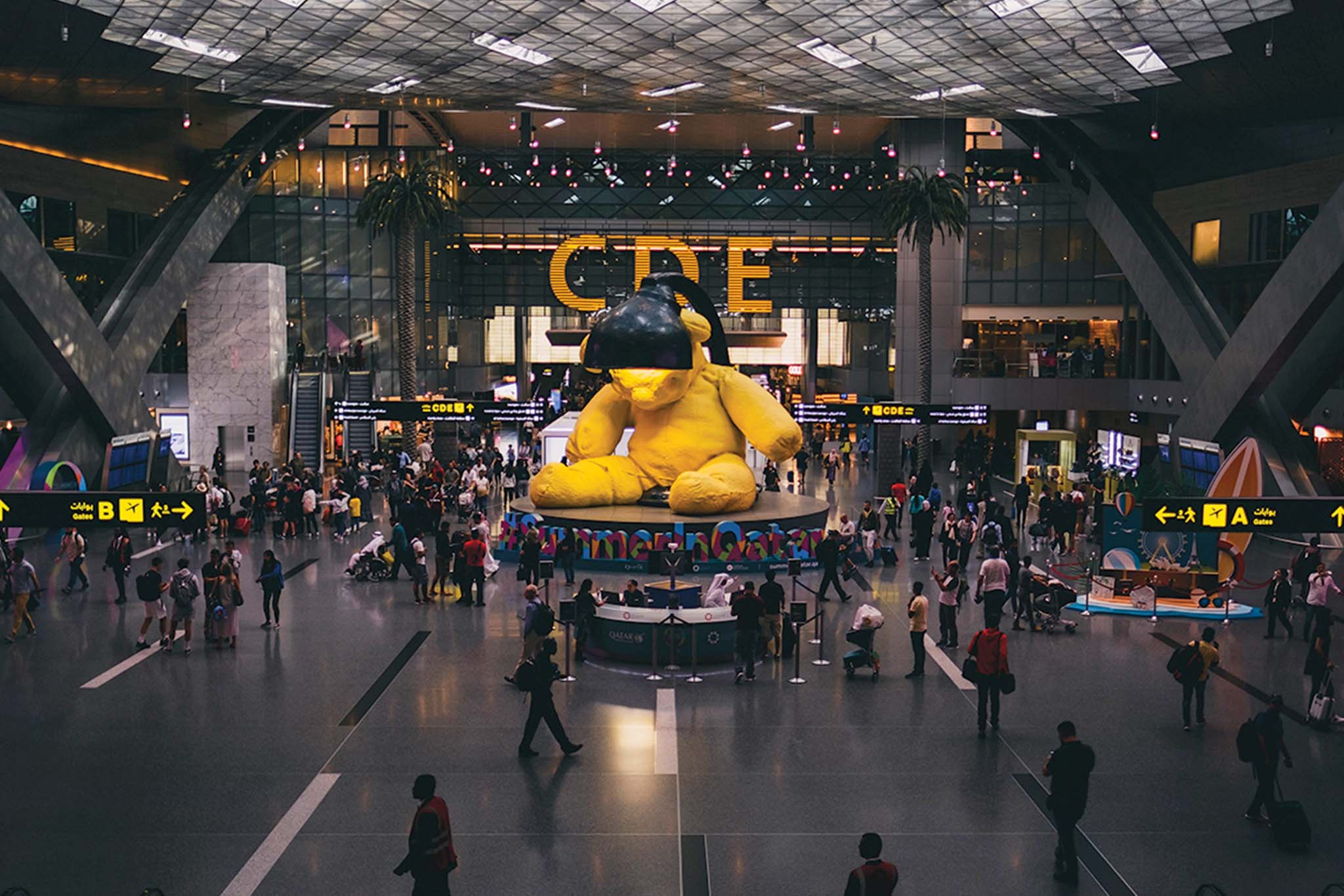 a large yellow stuffed bear in a large building