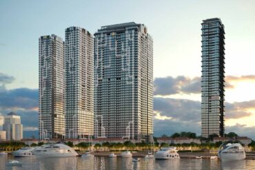 a group of tall buildings next to a body of water