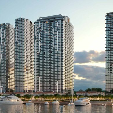 a group of tall buildings next to a body of water