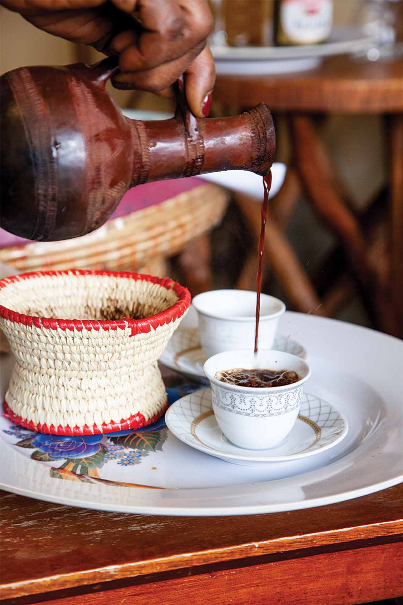 closeup of a person pouring a drink into a cup